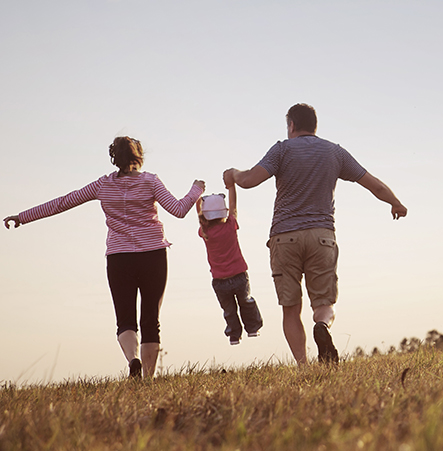 Parents swinging a child in the air