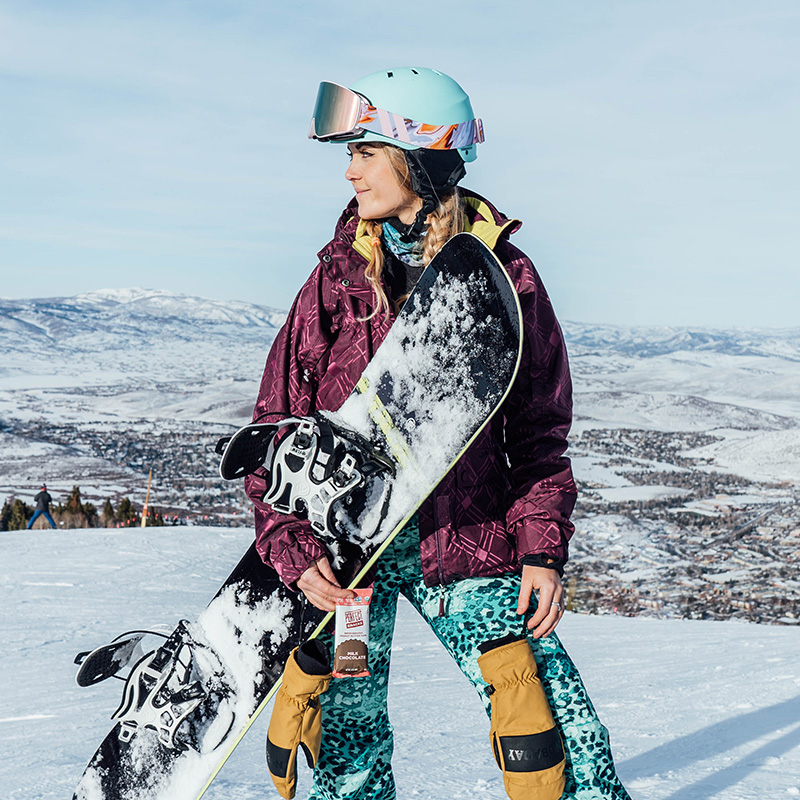 Young snowboarder holding snowboard